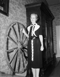 Mrs. W. Lee O'Daniel examines old wagon wheel