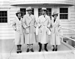 Carter family wearing white overcoats and hats