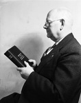 F. H. Camp, field representative of the Gideons, the Chrstian Commercial Men's Association of America, International, with one of Bibles to be placed in Worth Hotel rooms