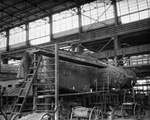 Texas and Pacific Railroad; men working on railway cars in roundhouse