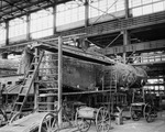 Texas and Pacific Railroad; man working on railway cars in roundhouse