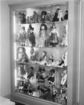 Doll collection in lighted cabinet in the C. A. Lupton home in River Crest, Fort Worth, Texas