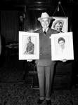Mr.Carter holding potraits of Amon Jr. and Ruth