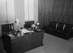 James R. Record at his desk