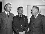 Lieutenant Colonel Charles H. Dowman (center) of Randolph Field being greeted by Joe D. Johnson (left) and H. C. Vandervoort