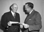 E. A. Landreth (right) presenting Doctor Charles H. Harris with $35,000 check