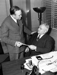 E. A. Landreth giving Ed H. Winton check for Texas Christian University (T. C. U.) fund
