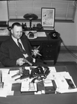 Fort Worth Police Chief Howard inspecting weapons after a vice raid by his department