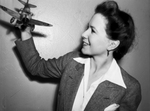 Mrs. Earle N. Williams, shown with her miniature airplane