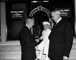 Harry Keeton Sr. (right) buys war bonds for 2-year-old son Harold George Keeton, Fort Worth, Texas