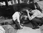 C. B. Tillery and son, Joe Neil, looking at tires