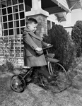 Joe Neil Tillery riding a tricycle