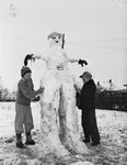 Snow Scenes. J. V. Perdue Jr. and Gerald Perdue making a snow man.