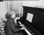 Mrs. Lily K. Andujar at the piano