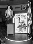 Miss Marion Lewis, depositing her auto license plates in lobby of Bowie Theater
