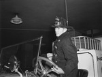 Fort Worth fire fighter Chick D. Boone at the wheel of a fire engine
