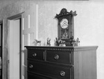 Dresser with clock and statues