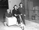 Tom M. Girdler piloting a scooter