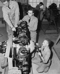 North Texas Agricultural College (N. T. A. C.) wartime efforts include timing the valves and magneto on an airplane engine at the Lake Worth Bomber Plant