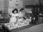 Miss Jeanette Turner and Mrs. Cycle Brown, inspecting trays for American Airlines