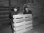 Inspecting wooden pallets at the Fort Worth Quartermaster Depot are Colonel John S. Chambers (left) and H. A. Ziegler