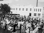 Dorothy Lamour with a group of war industry workers and their families at Texasteel plant during a war bond drive