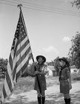 Boy Scouts Scout Richard Miller (left) and Perry Hale looking at a flag