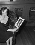 Mrs. Mittie Belle Lightfoot, looking at photo of her son