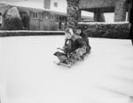 Ann Goodwin and Ralph Beaver riding on a sled