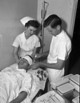 Emma Mae Costlow, nurse, Doctor Jame McBride and Lester Hovis, orderly, acting as patient