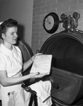 Emma Mae Costlow, student nurse, sterilizing a tray of instruments