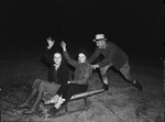 W. A. Schmid is giving Miss Isobel McFarland and Miss Jean Copeland a sled ride over the frozen Lake Worth