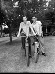 Forrest Shuttleworth (left) and Arthur Payne on bicycles