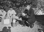 Fireman L. B. Gonzales and Bttalion Chief A. E. Rodgers with air raid warning mortars