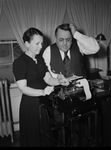 J. Walter Morris in an adding machine session with Mrs. Clyde Reeder