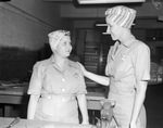 War Industries Training School, Mrs. J.C. McCaig (left) learns how to work around machinery; other woman not identified, 01/06/1943