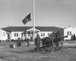 Retreat soldiers saluting lowering of flag as cannon booms