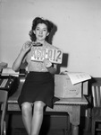 Mrs. Dorothy Smotherman comparing old and new automobile license plates