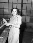 Mrs. C. C. Schuchard works with rivet machinery at War Industries Training School
