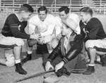Quarterback for Philadelphia Eagles Davey O'Brien, left, huddles with Texas Christian University (T. C. U.) players during spring training