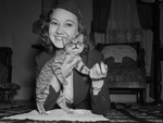 Miss Ovaleen Kelly and a cat that rode the rods of a streamlined train from Dallas to Houston