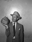 Ernest Retz holding huge sweet potato