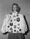 Faye Saxon shown with coat and collection of insignia