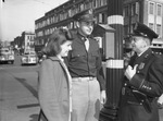 Lieutenant and Mrs. L. E. Shaw shown with Patrolman V. P. Howell