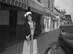 Fort Worth Police Department. Women. Miss Marie Crane, secretary to Police Chief Curry, checking parking meter