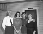 Staff Sergeant James R. Taylor with his parents, Mr. and Mrs J. R. Taylor, and his wife.