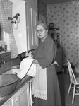 Mrs. R. L. Buster, Abilene Chief of Police. Mrs. Robert L. Buster in her kitchen