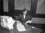 Miss M. Gladys Pittenger, head of Welfare Department, at her desk
