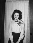 Miss Bonnie OsBurn, Texas Christian University (T. C. U.) freshman, who receives flowers from an unknown admirer