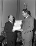 Frank Kent, outgoing president of the Exchange Club, receives past president's certificate from J.A. Gooch at the Fort Worth Club, 12/22/1943